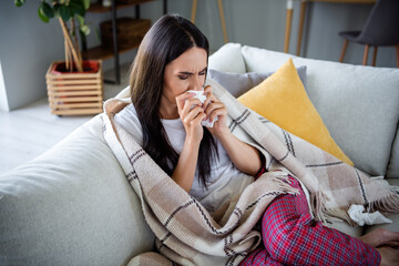 Portrait of nice young woman blow running nose napkin wear pajama pastime living room flat indoors