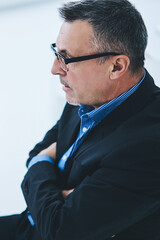 Male and female partners collaborating togetherness in office of finance company sitting near desktop with architect blueprints and smartphone gadget with blank screen area for internet advertising