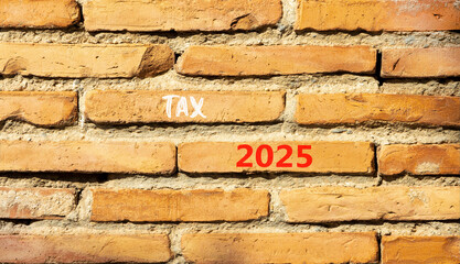 Planning tax 2025 new year symbol. Concept words Tax 2025 on beautiful brown brick wall. Beautiful brown brick wall background. Business tax 2025 new year concept. Copy space.