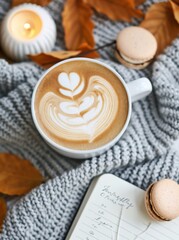 Warm Coffee With Heart Latte Art and Macarons on Cozy Knit Blanket in Autumn