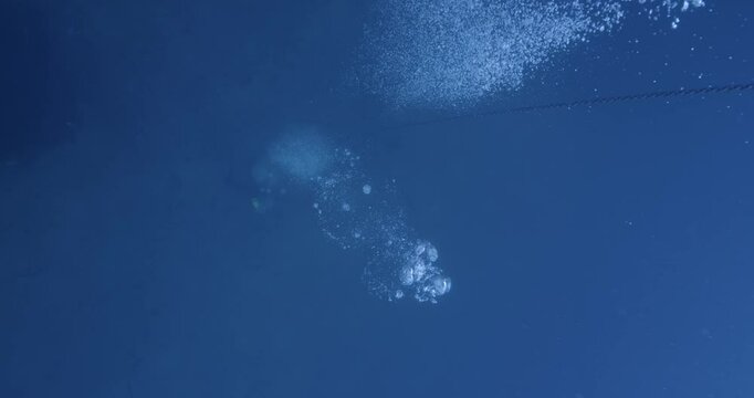 Scuba diver on seabed as seen from surface.