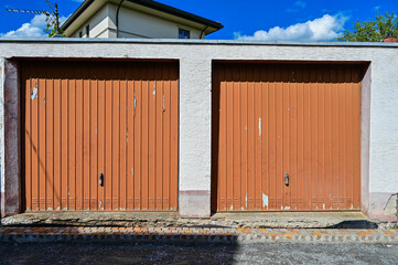 Old double garage with brown doors with weathered paint, garage door, garage complex, Seligenstadt,...