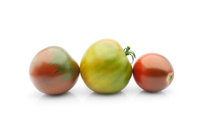 Three organic multicolored tomatoes isolated on white background