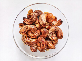 Cashew nuts. Roasted cashew nuts with shell in a bowl. Grilled cashew nuts. Top view.