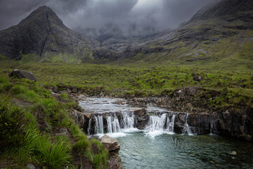 Beautiful waterfalls at the Fairy Pools, the waterfalls that flow from the River Brittle, with the Black Cuilins mountains on the Isle of Skye in the background.