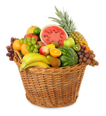Many different fresh fruits in wicker basket isolated on white