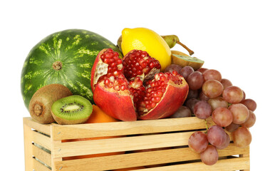 Many different fresh fruits in wooden crate isolated on white