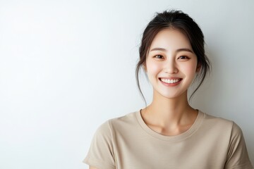 Fototapeta premium Portraits of Asian women in simple casual attire, standing against plain white background, wear minimal makeup display natural expressions, emphasizing modern, everyday style.