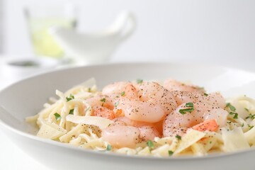 Delicious pasta with shrimps and cheese on table, closeup