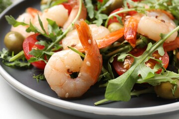 Delicious shrimp salad with tomato and olives on table, closeup