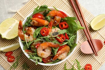 Delicious shrimp salad with vegetables in bowl served on grey table, flat lay