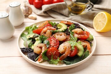 Delicious shrimp salad and ingredients on white wooden table, closeup