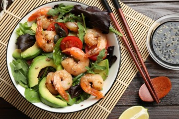 Delicious shrimp salad on wooden table, flat lay