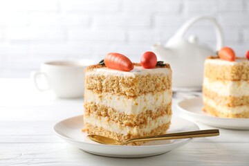 Piece of delicious carrot cake on white wooden table, closeup