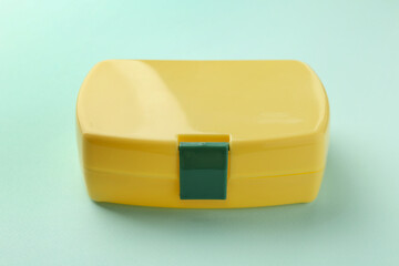 One yellow lunch box on light blue background