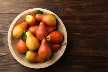 Ripe juicy pears on wooden table, top view. Space for text