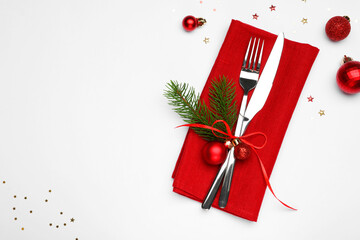 Christmas table setting. Cutlery, napkin and festive decor on white background, flat lay. Space for text