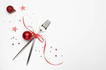 Christmas table setting. Cutlery and festive decor on white background, flat lay. Space for text