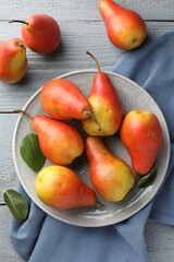 Ripe juicy pears on grey wooden table, flat lay