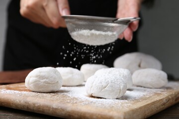 Woman making tasty mochi at wooden table, closeup