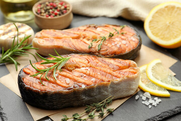 Tasty grilled salmon steak with spices on table, closeup
