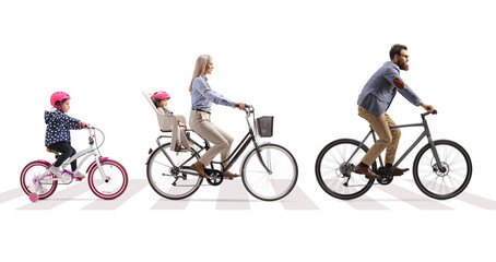 Obraz premium Parents with children riding bicycles on a street