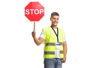 Young man in a reflective safety vest holding a stop traffic sign