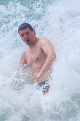 Man 25-30 old swims in a strong storm at sea