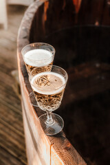 Two glasses of champagne , relaxing in hot tub.