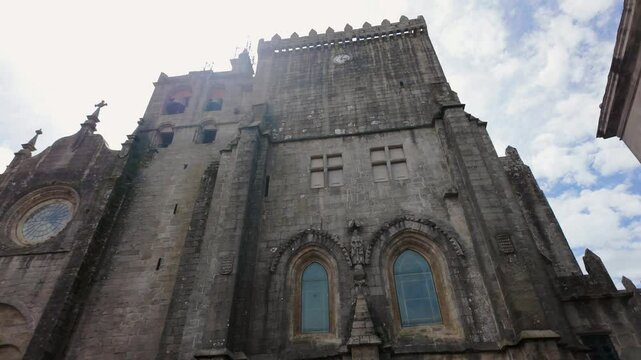 Medieval cathedral in the city of Tui with the sun entering between the towers, Galicia, Spain.