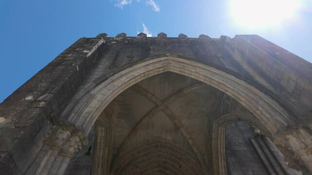 Medieval cathedral in the city of Tui with the sun entering between the towers, Galicia, Spain.