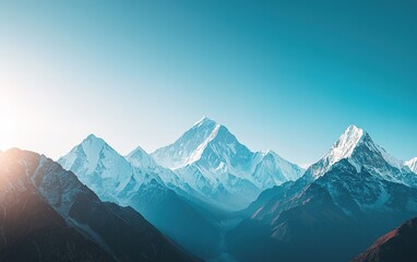 Fototapeta premium Majestic snow-capped mountains illuminated by the golden sunrise over a serene valley during early morning hours