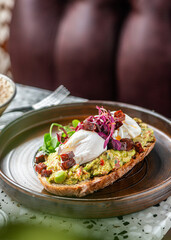 Avocado guacamole toast with poached eggs on top. Brunch food. 