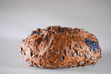 Whole meal bread roll isolated on breakfast table