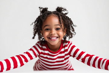 young black girl in red and white striped pajamas, smiling ,isolated on a white background. 