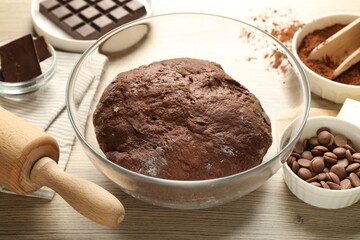 Chocolate dough and ingredients on wooden table, closeup