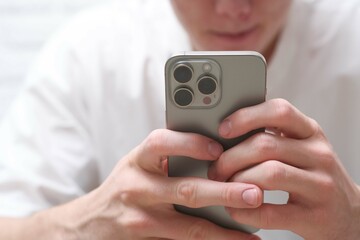 A CloseUp View of Hands Firmly Holding a Smartphone in a Contemporary Modern Setting