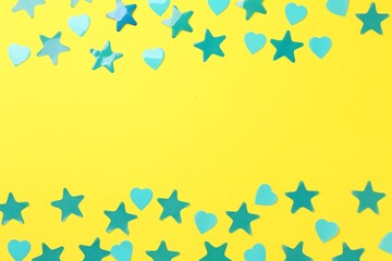 Beautiful confetti on yellow background, flat lay. Space for text