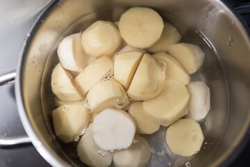 A pot of potatoes is boiling in water