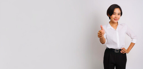 A portrait of a Southeast Asian businesswoman wearing a white dress shirt and giving a thumbs up.