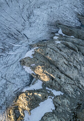 Aerial View of Rugged Glacier Landscape with Rocky Terrain in BC, Canada Capturing Natural Ice Formations