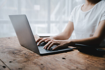 Close-up portrait typing keyboard on laptop computer. Working online on white table at office. Facebook chat. Website meeting. Blogger. Journalist writing articles. online job ideas.