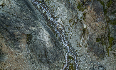 Aerial View of Rugged Mountain Terrain with Stream in British Columbia, Canada