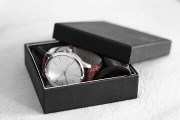 Elegant analog wristwatch with a brown strap, packed in a black gift box with a lid