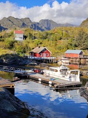 Fototapeta premium Village on the coast under the mountains in northern Norway beautiful nature