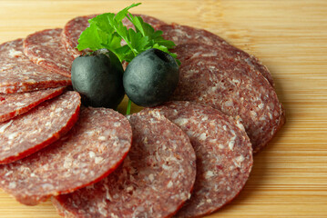 Sliced smoked sausage arranged in a perfect circular display.