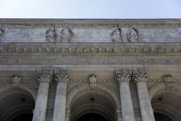 Striking façade of the New York Public Library, featuring towering columns and elegant sculptures...