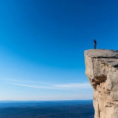 Cliff climber reaching the summit, expansive landscape below, moment of triumph