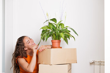 Young woman very happy to have bought her own house. A flat just for her. She is a homeowner, happily single. Fulfilling a dream. A new stage. Beginnings, new house, new life. Time to pay the mortgage