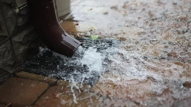 Roof drain pipe. Rainwater downpipe. House drainage system during a rainstorm.